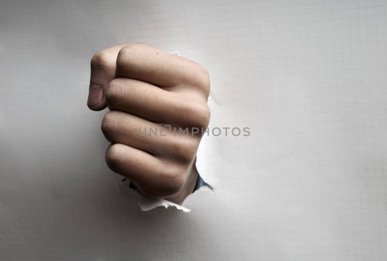 Paper broken by the fist as a symbol of the danger