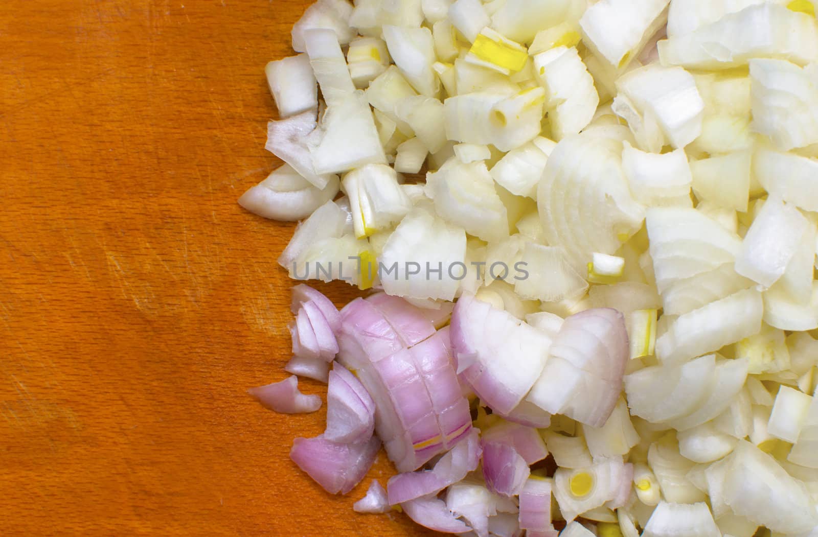 chopped raw onions on board
