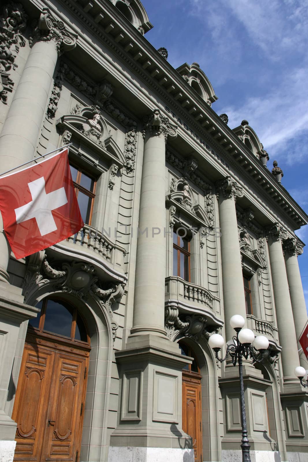 City theater in Berne, Switzerland. Old landmark with Swiss flag.
