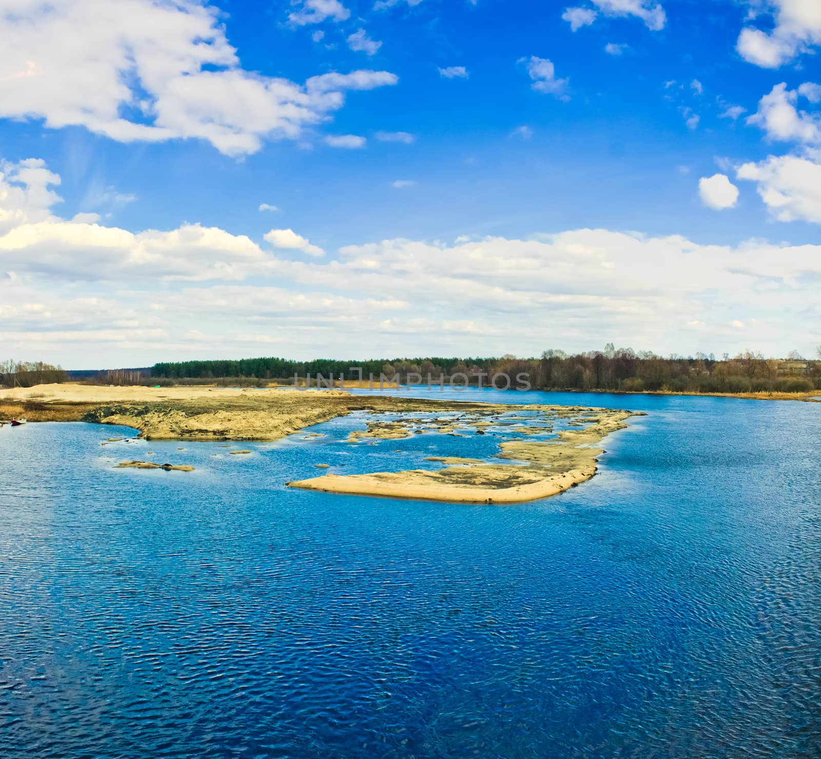 Island with trees on blue cold lake by ryhor