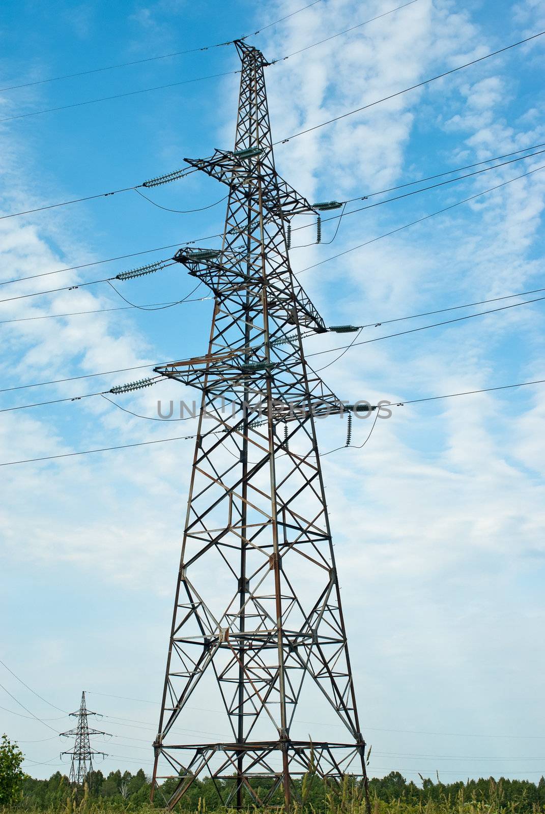 High voltage power lines over blue sky