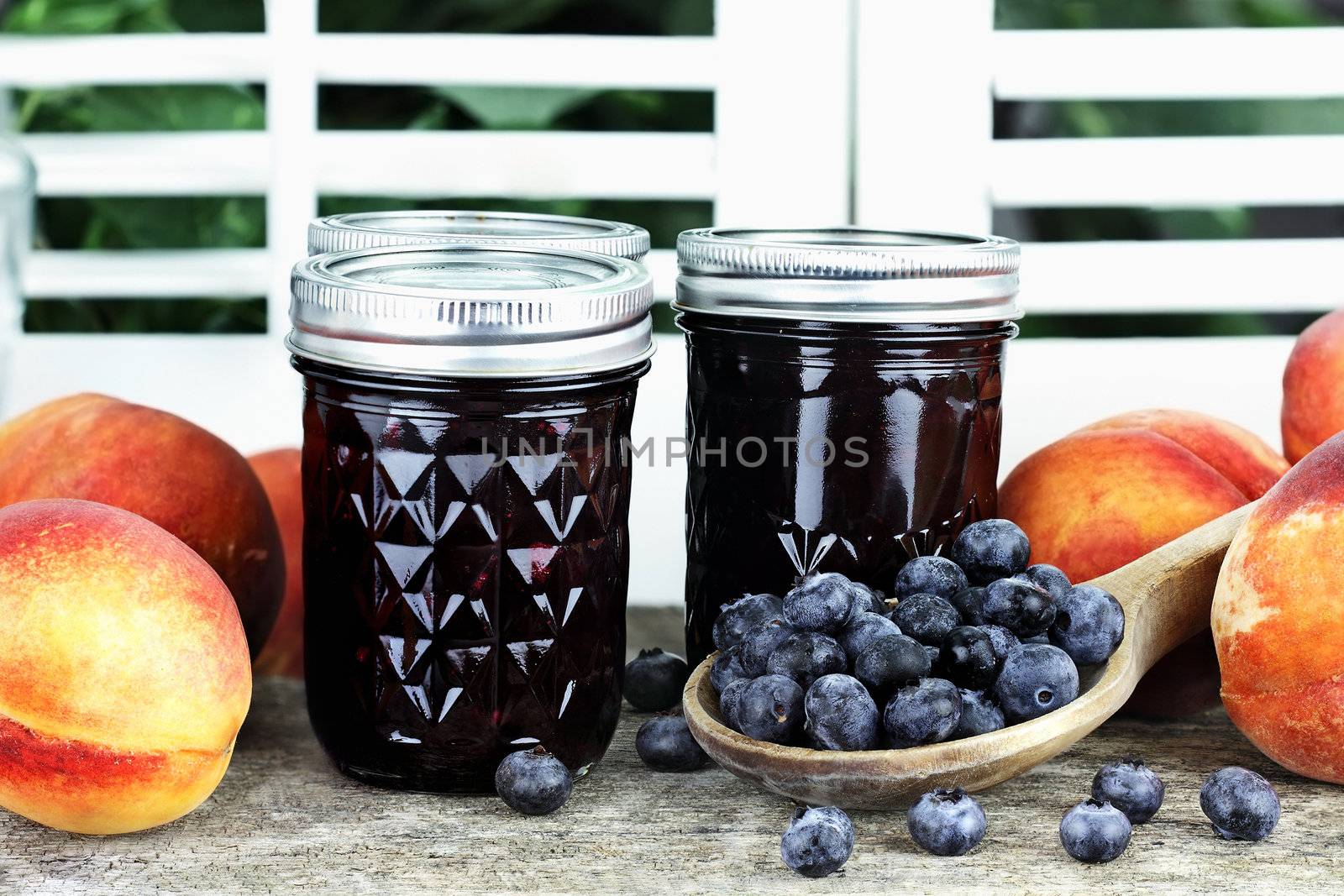 Homemade canned blueberry peach preserves with fresh blueberries and peaches.