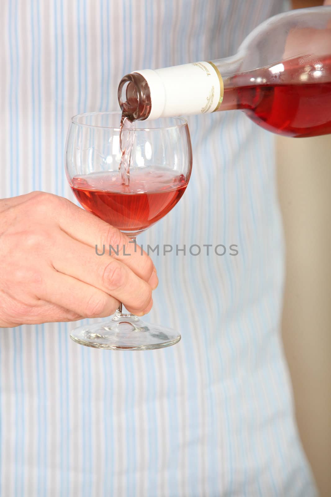 Man pouring glass of rose