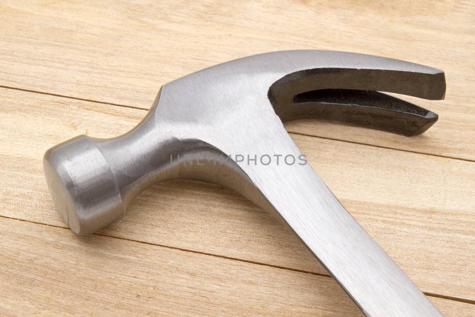 Hammer isolated on wood background