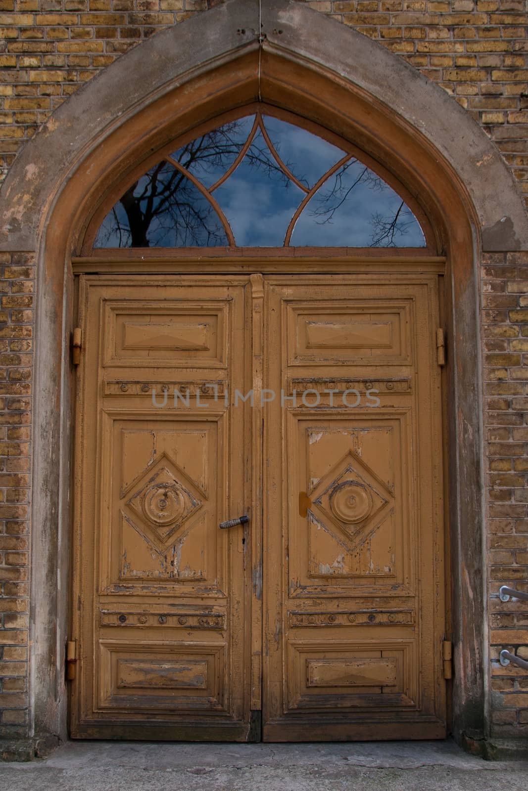 Ancient brown wooden door with glasses