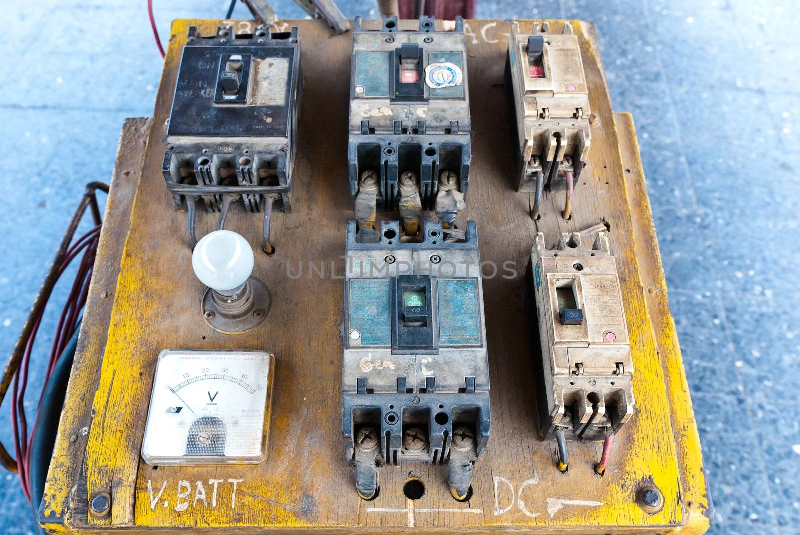 Vintage electrical circuit board and controller taken on sunny day
