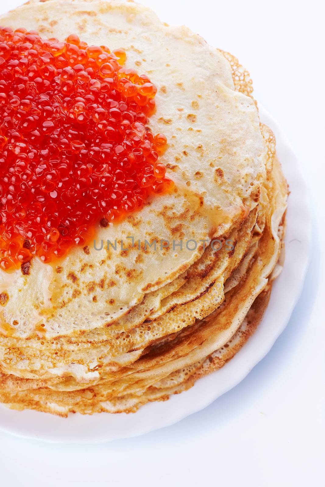 Pancakes with red caviar. Pile of pancakes. Pancakes on a plate. Red caviar.
