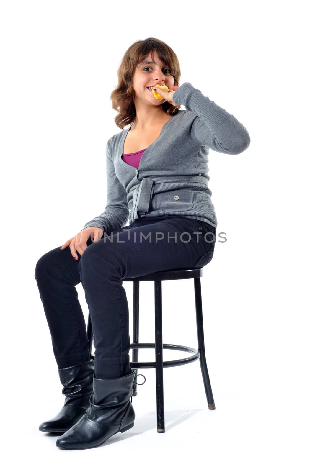 beautiful teenager eating an apple in front of a white background