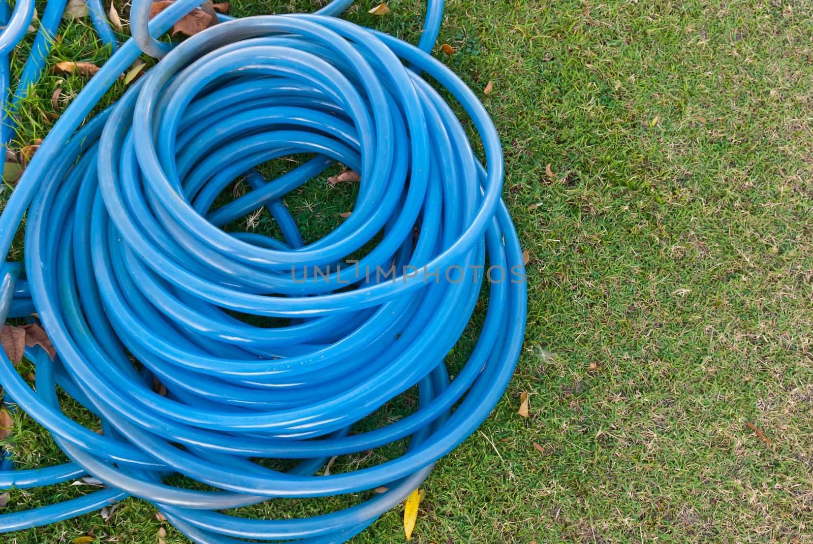 Blue garden water hose stack together by sasilsolutions