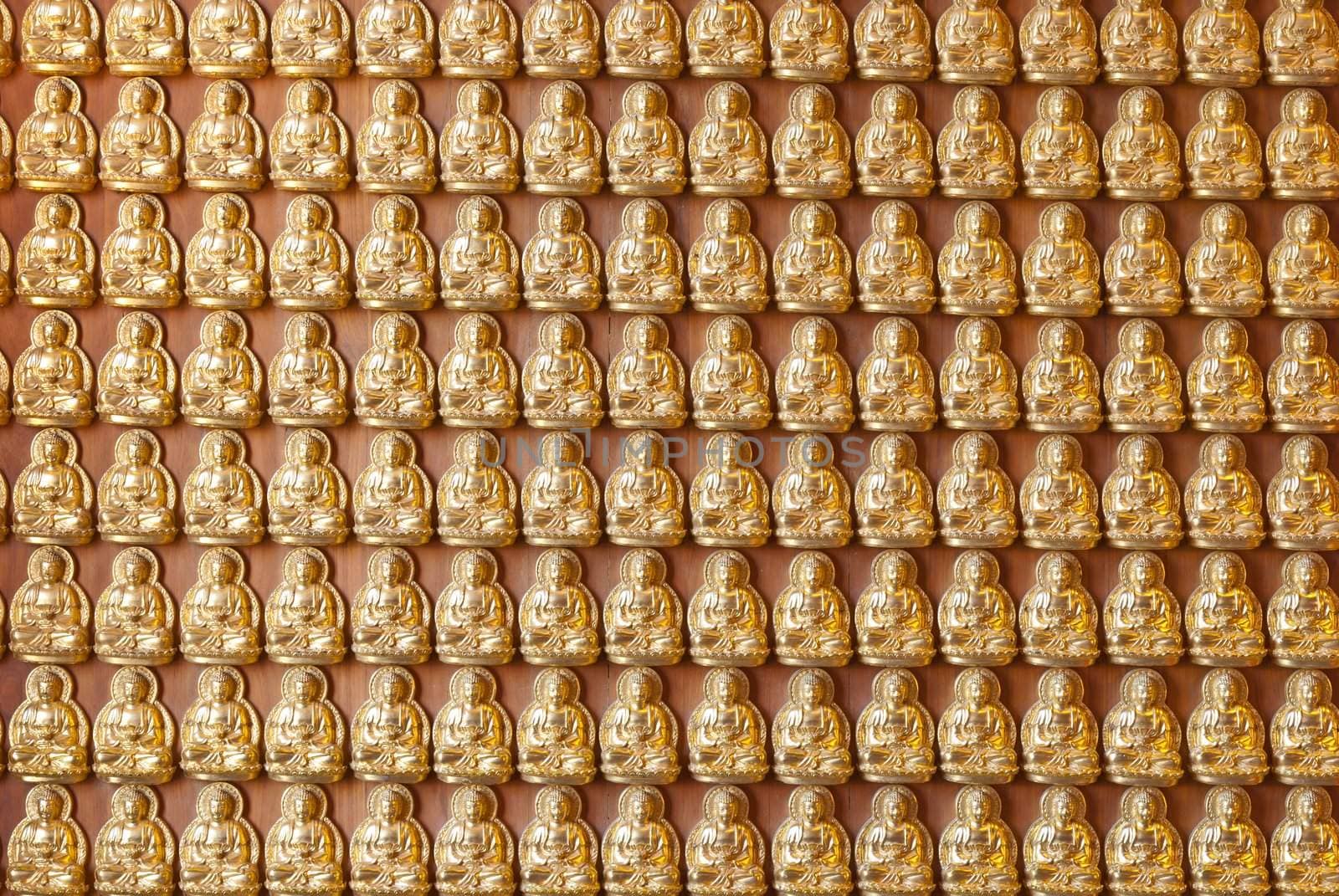 Hundreds of golden Buddha statues background at chinese temple