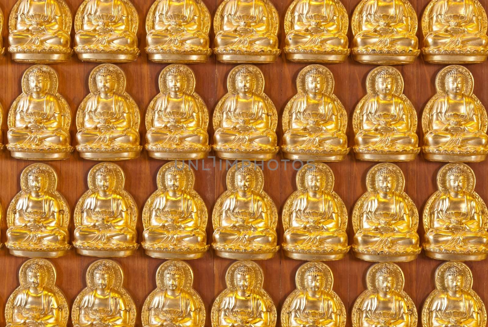 Hundreds of golden Budhha statues background by sasilsolutions