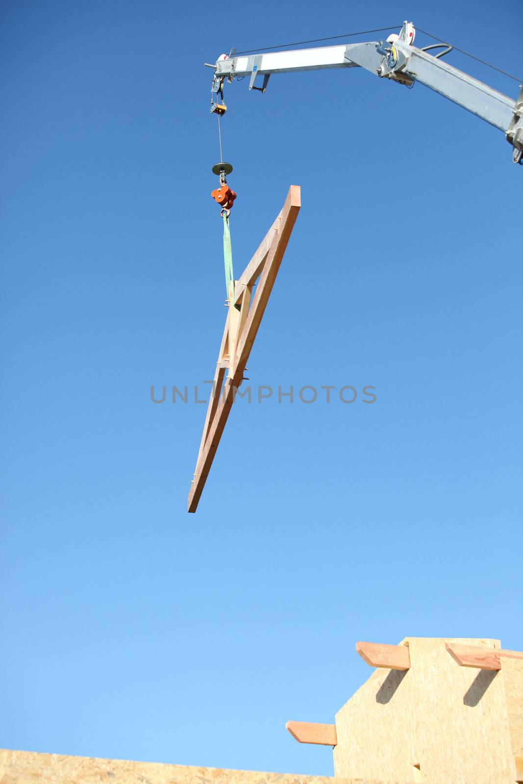 crane lifting wooden frame by phovoir