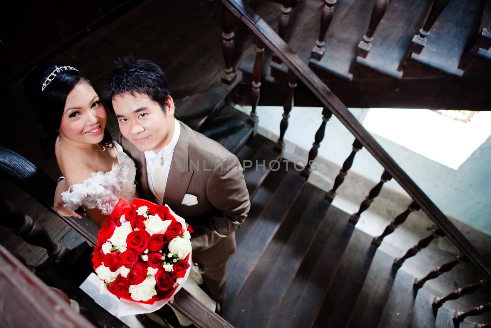 Bride and groom with roses bouquet