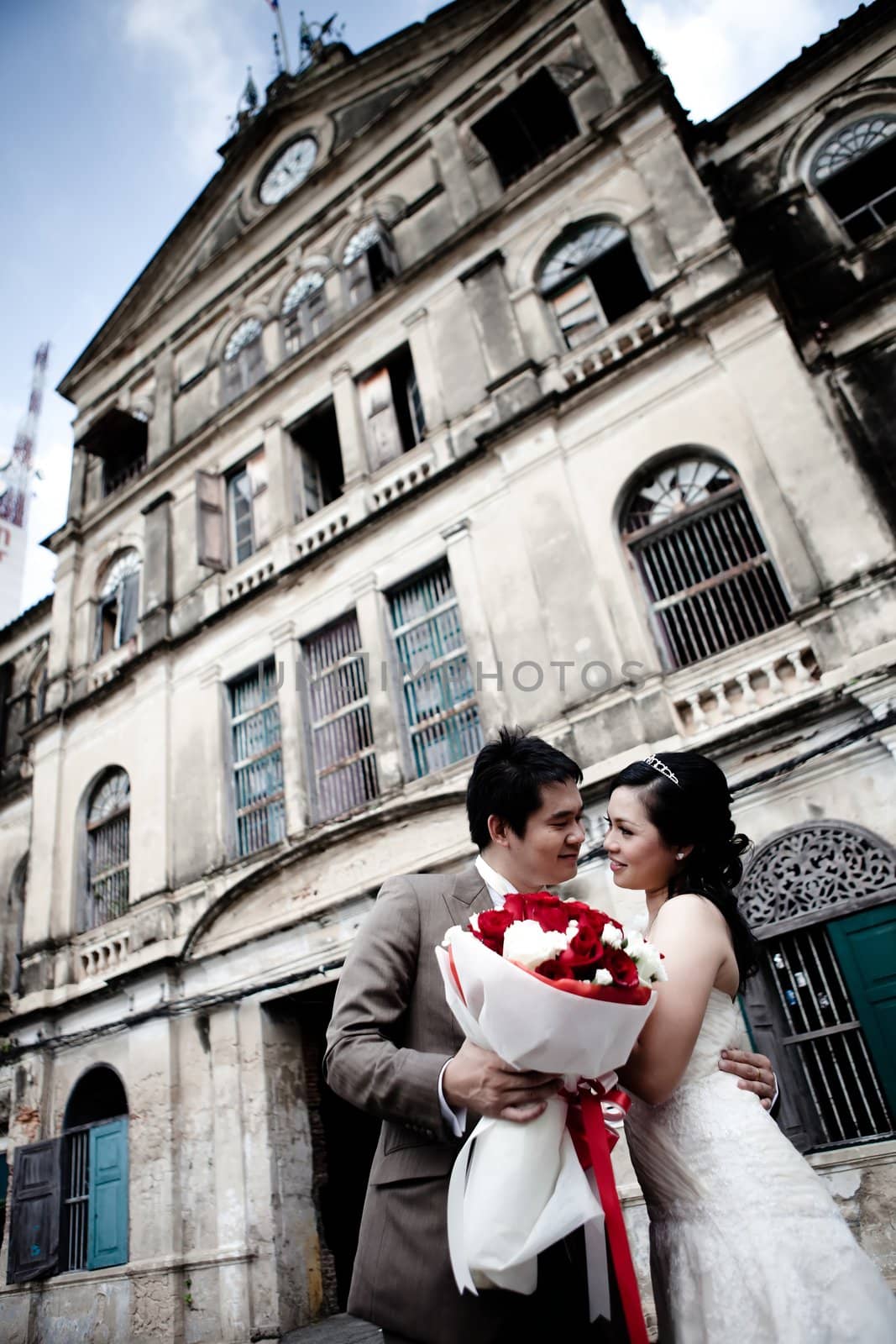 Bride and groom seeing each other at old building