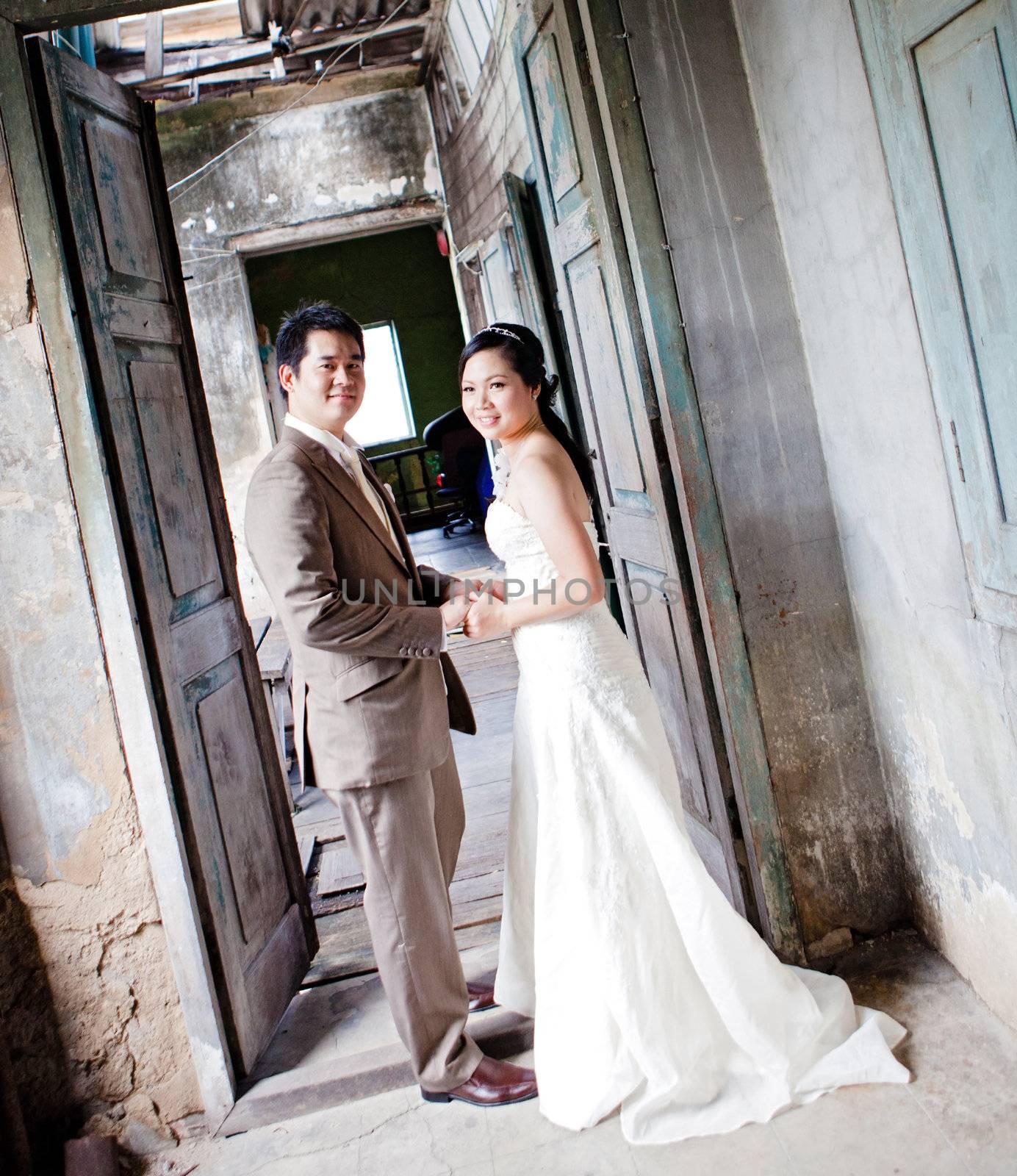 couples of groom and bride portrait in old church after wedding ceremony