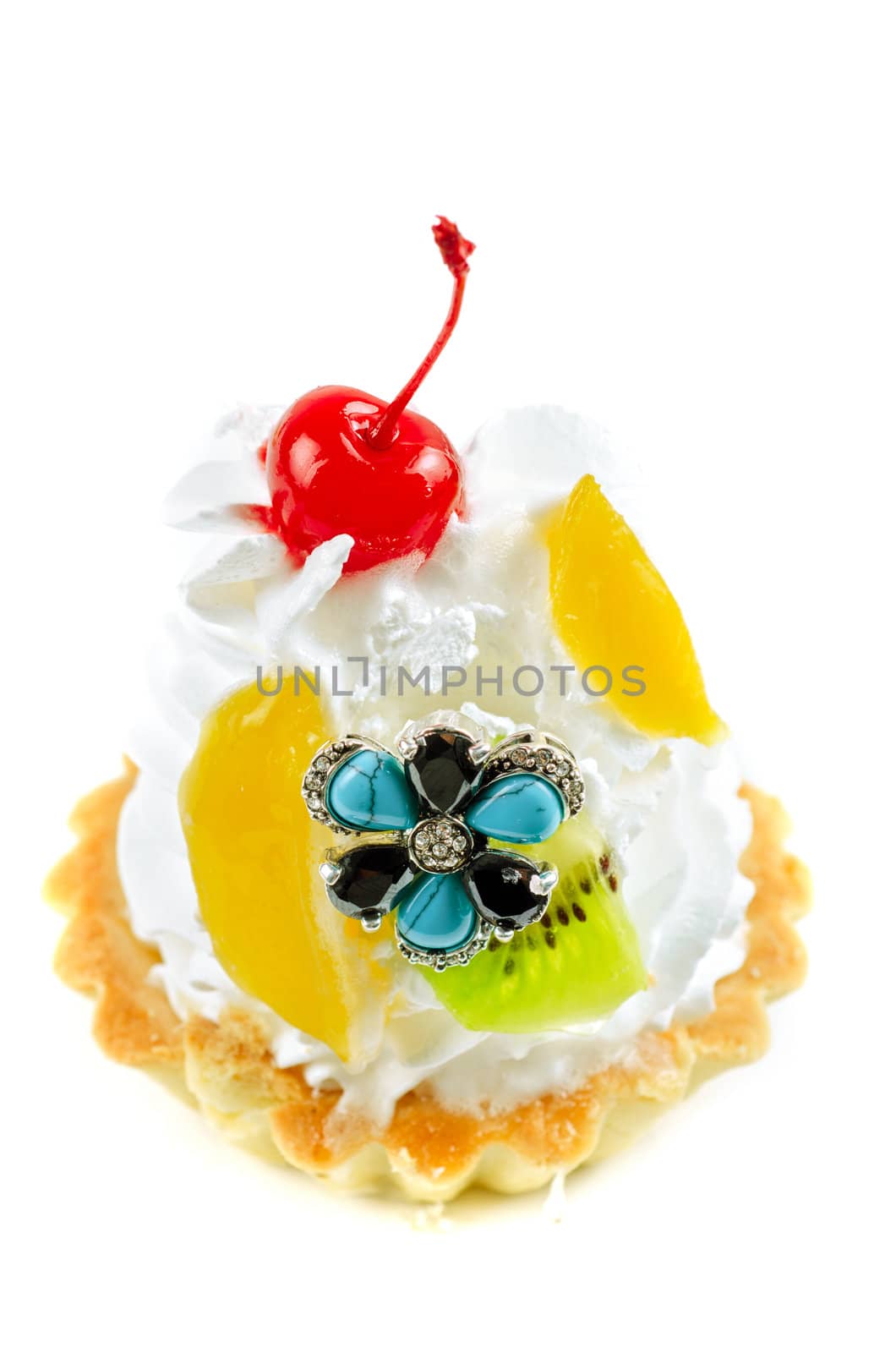 cupcake and bijouterie flower on a white background