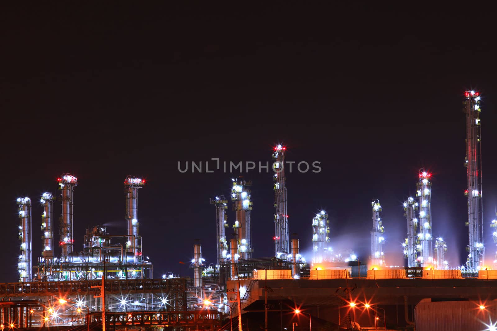 beautiful scenic of petrochemical oil refinery plant shines at night, closeup