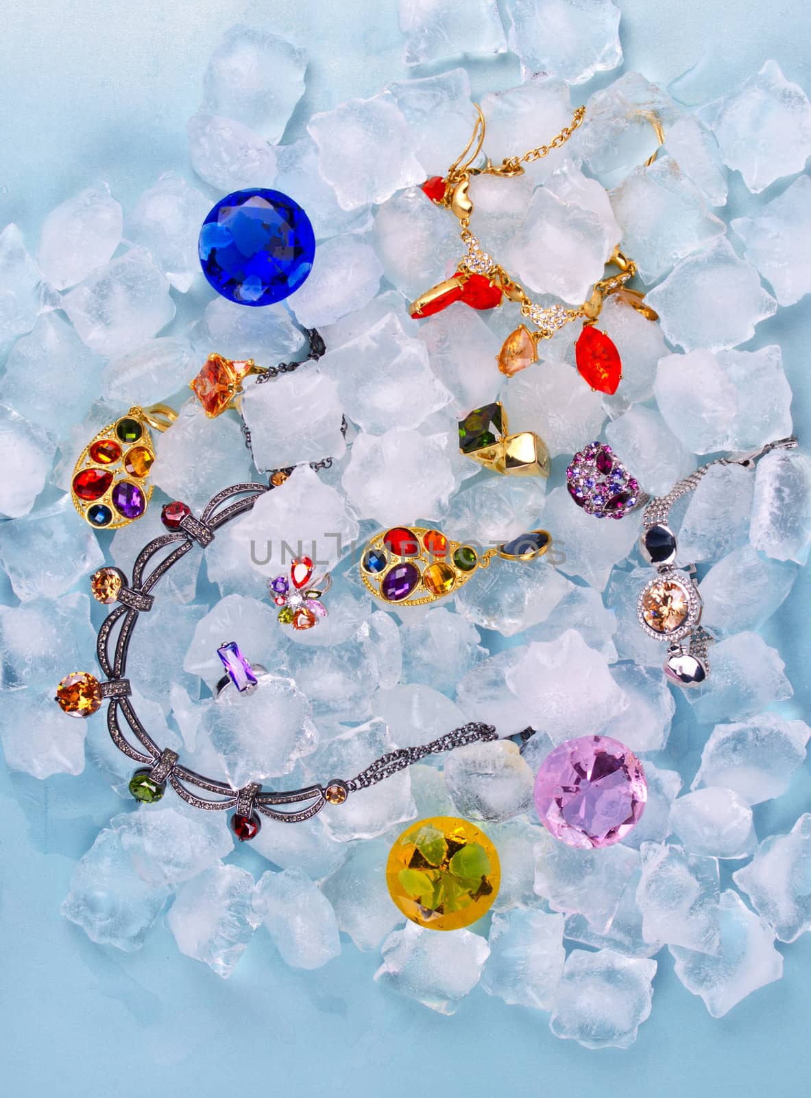 Jewels at blue cube of ice background
