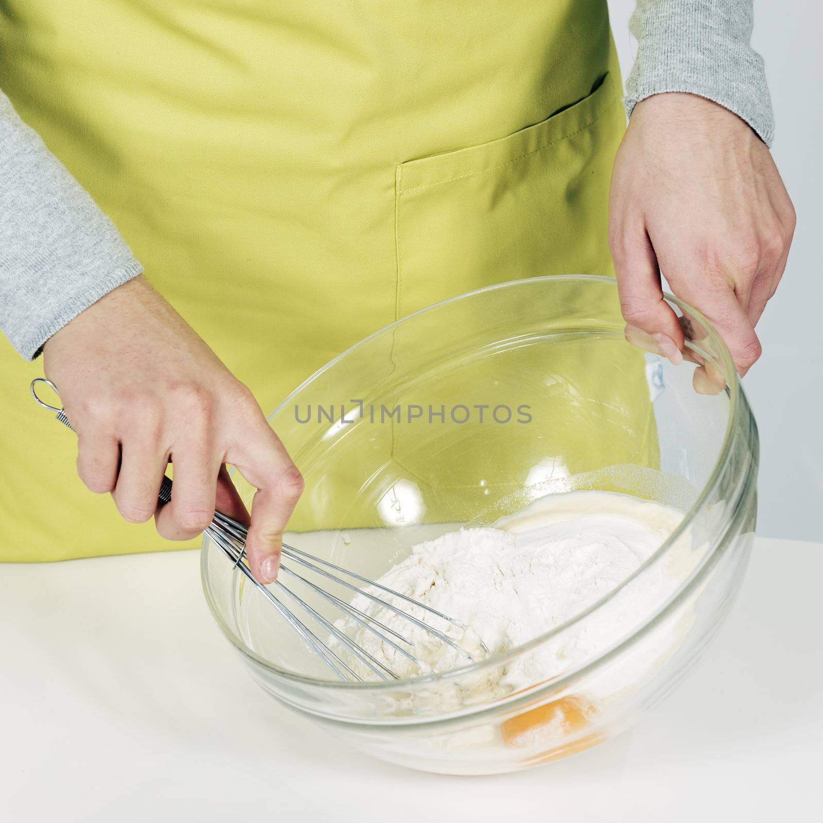 Woman hands whisking batter in kitchen