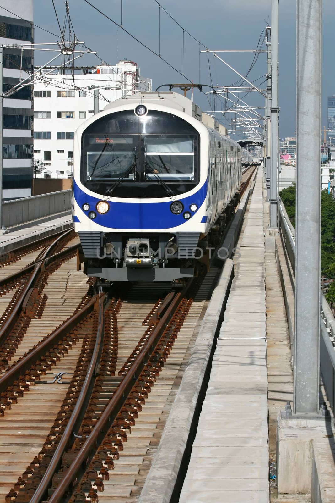 Blue Sky Train coming to Station in Bangkok Thailand