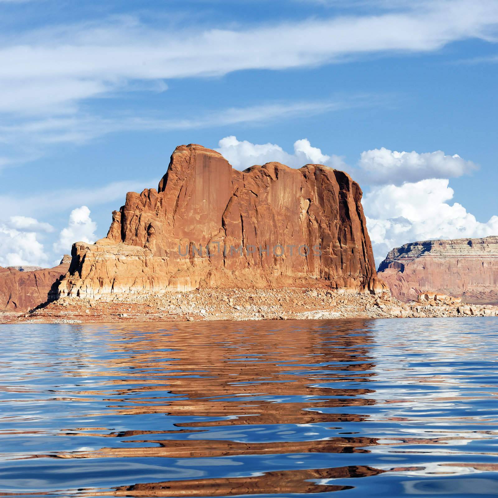 Red cliff reflected in the smooth water of the lake Powell