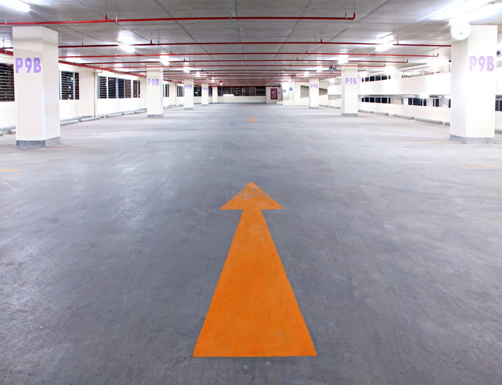 empty parking garage with yellow arrow