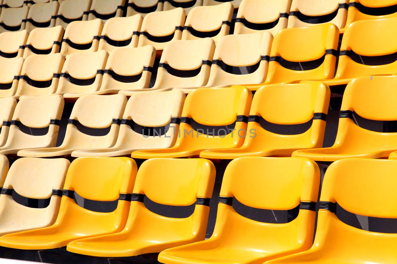 old and new yellow seat in stadium