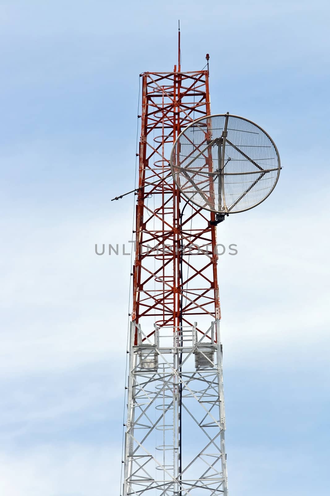 Satellite Dish on Telecommunication Radio antenna Tower with blue sky