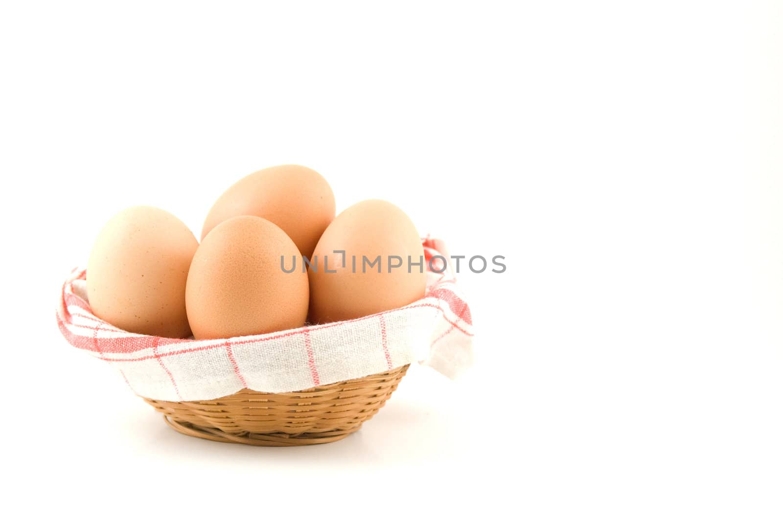 eggs in a wicker basket on white background