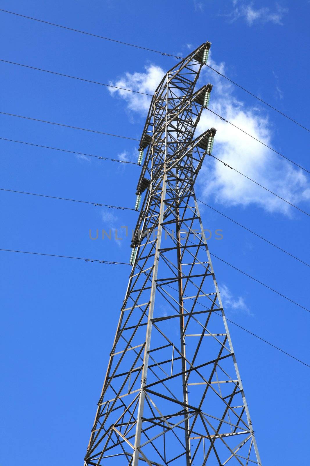 electric high voltage power post with sunny sky