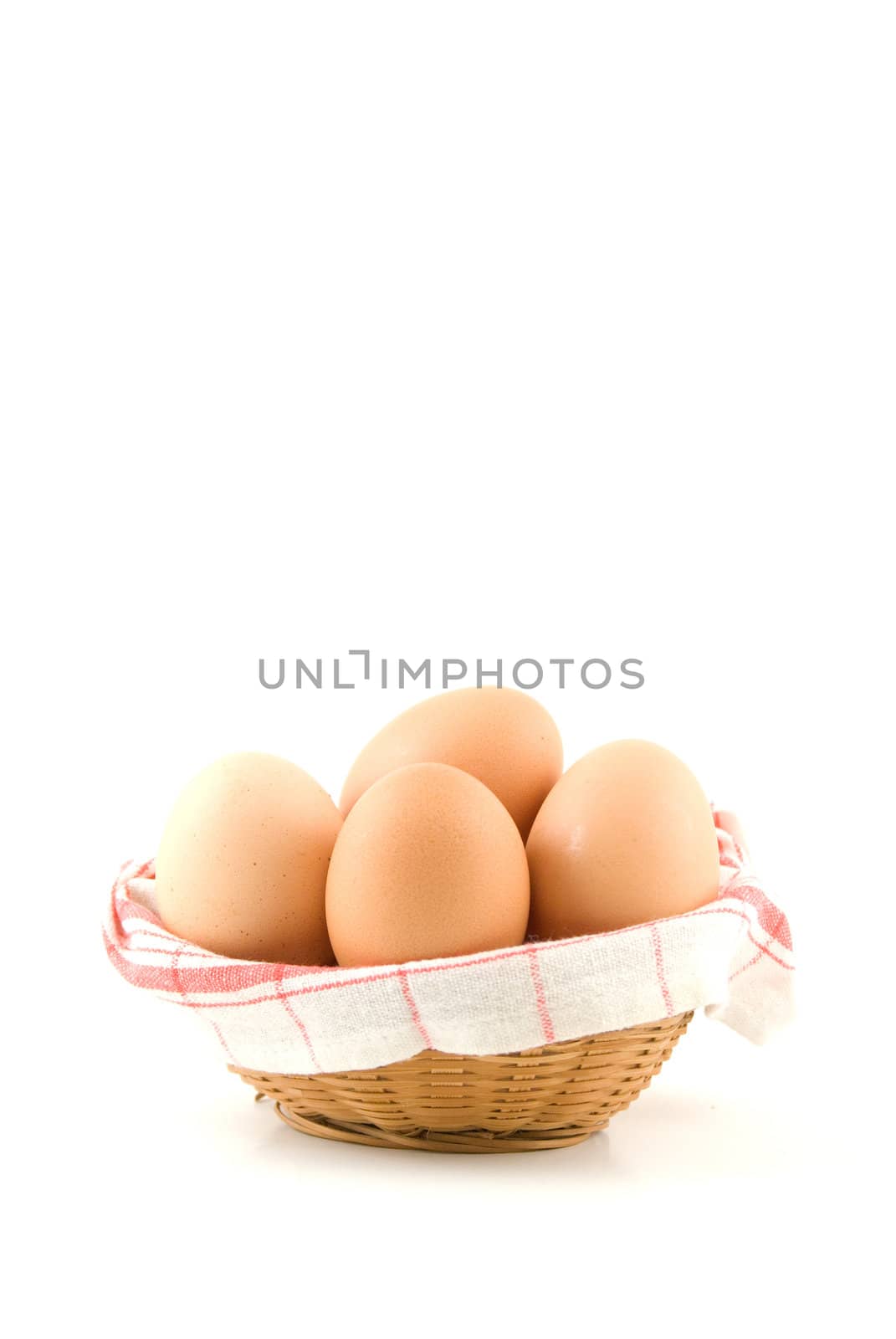 eggs in a wicker basket on white background