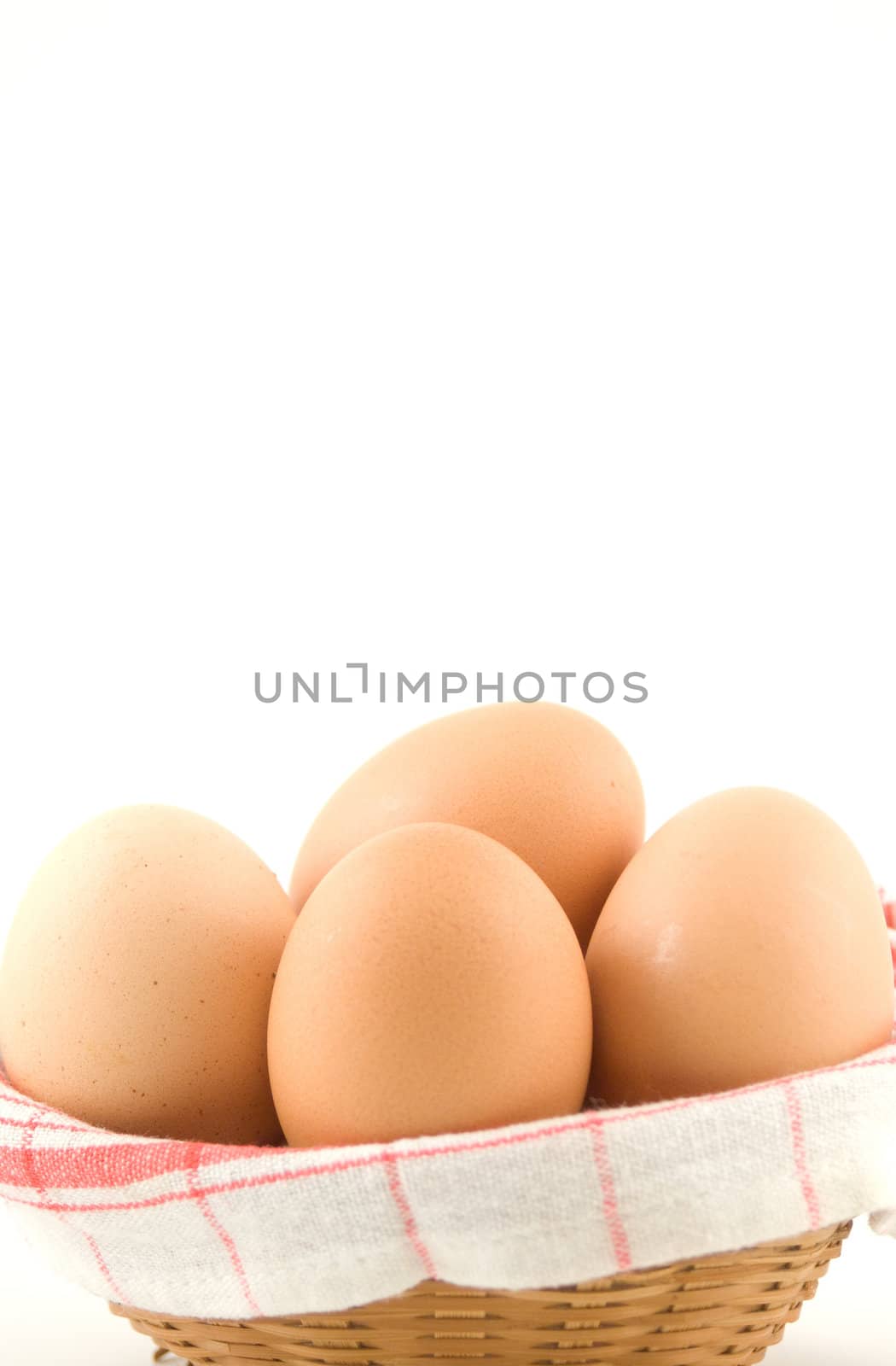 eggs in a wicker basket on white background