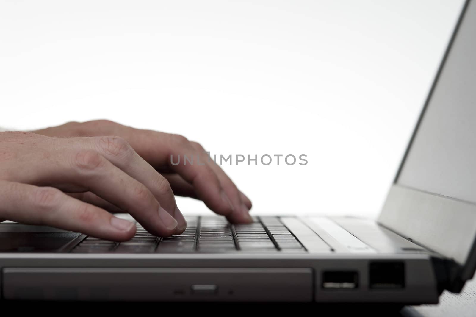 Hands Typing On Laptop Keyboard by stockarch