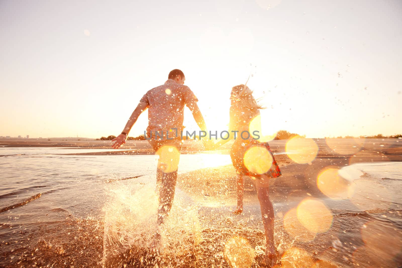 couple running on the beach by vsurkov