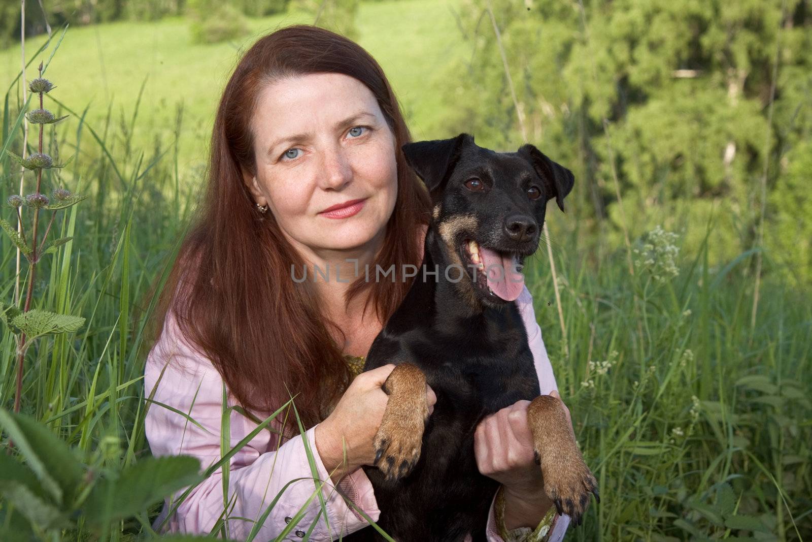 The woman with a dog on a marge of a wood