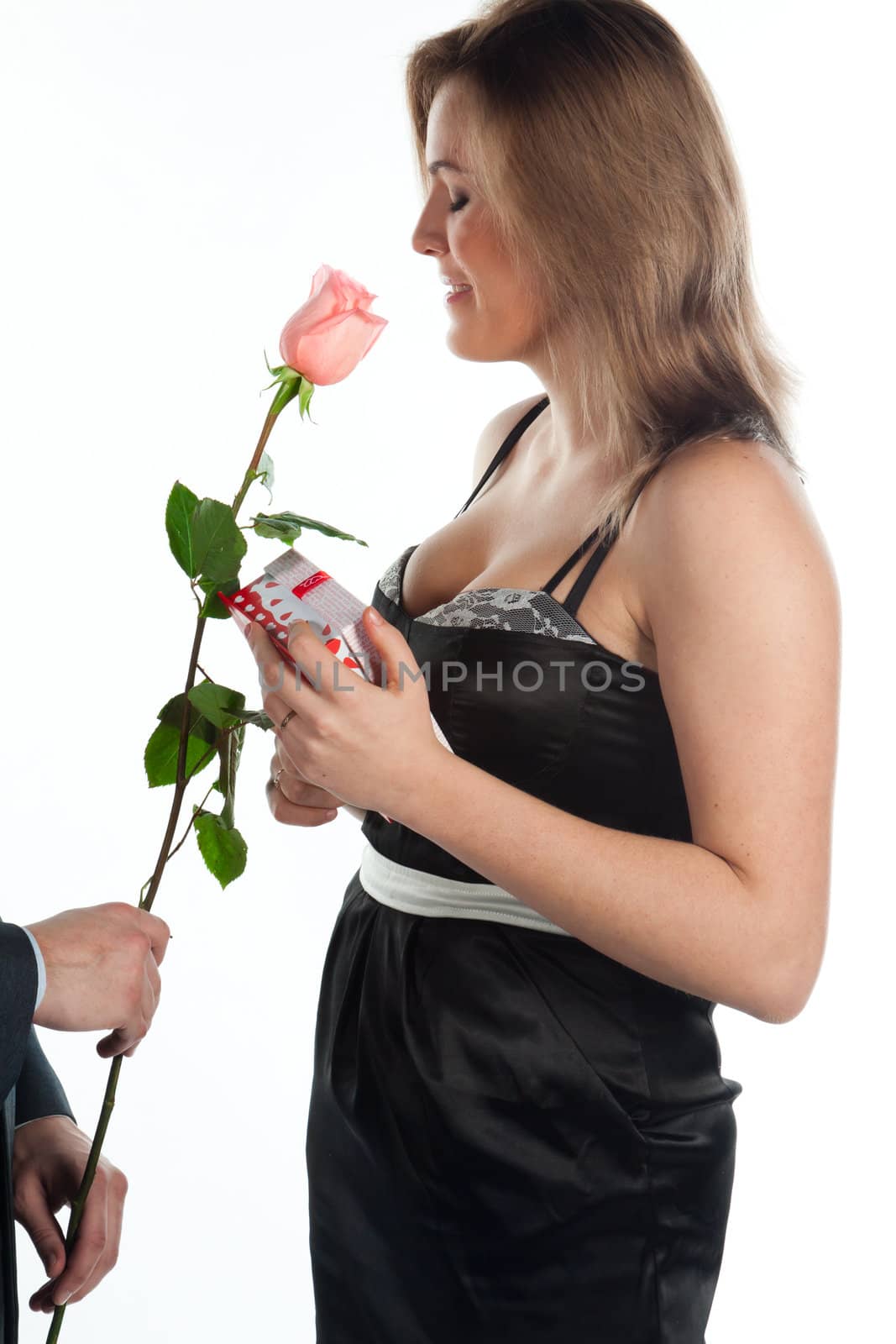 portrait of a young and beautiful girl with a gift and a rose