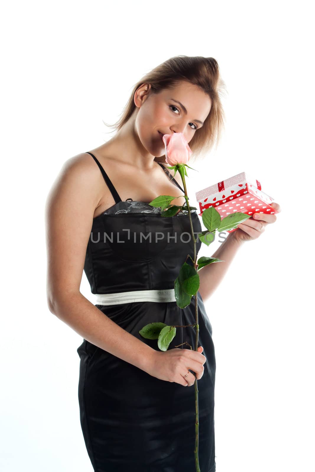 portrait of a young and beautiful girl with a gift and a rose