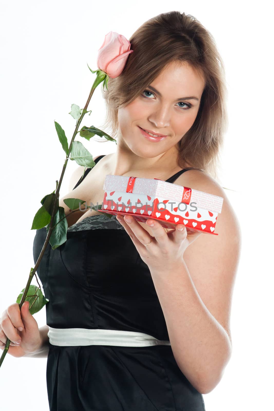 portrait of a young and beautiful girl with a gift and a rose