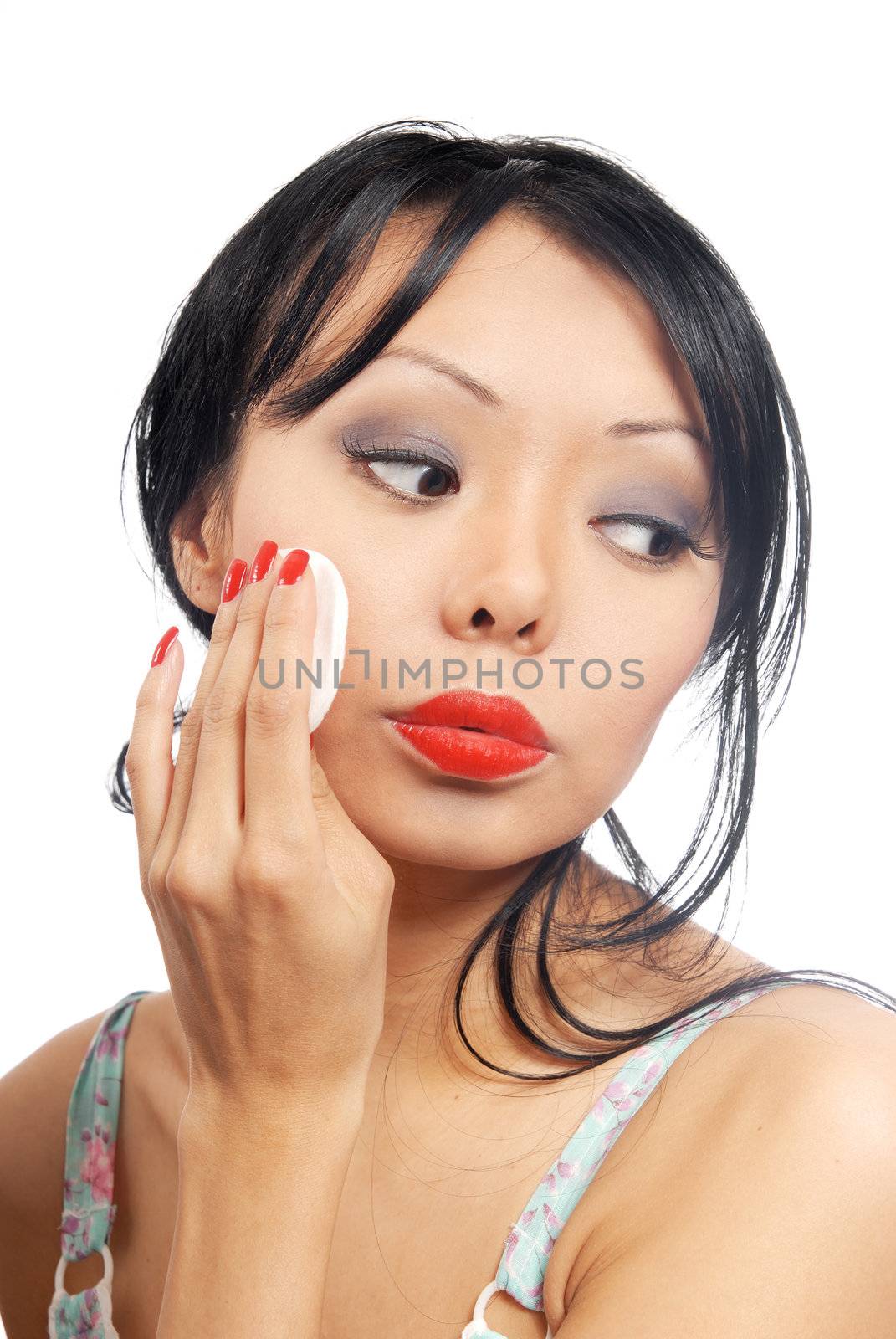 Portrait of the woman applying make-up sponge