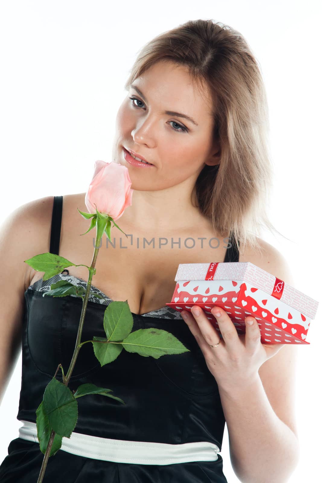 portrait of a young and beautiful girl with a gift and a rose
