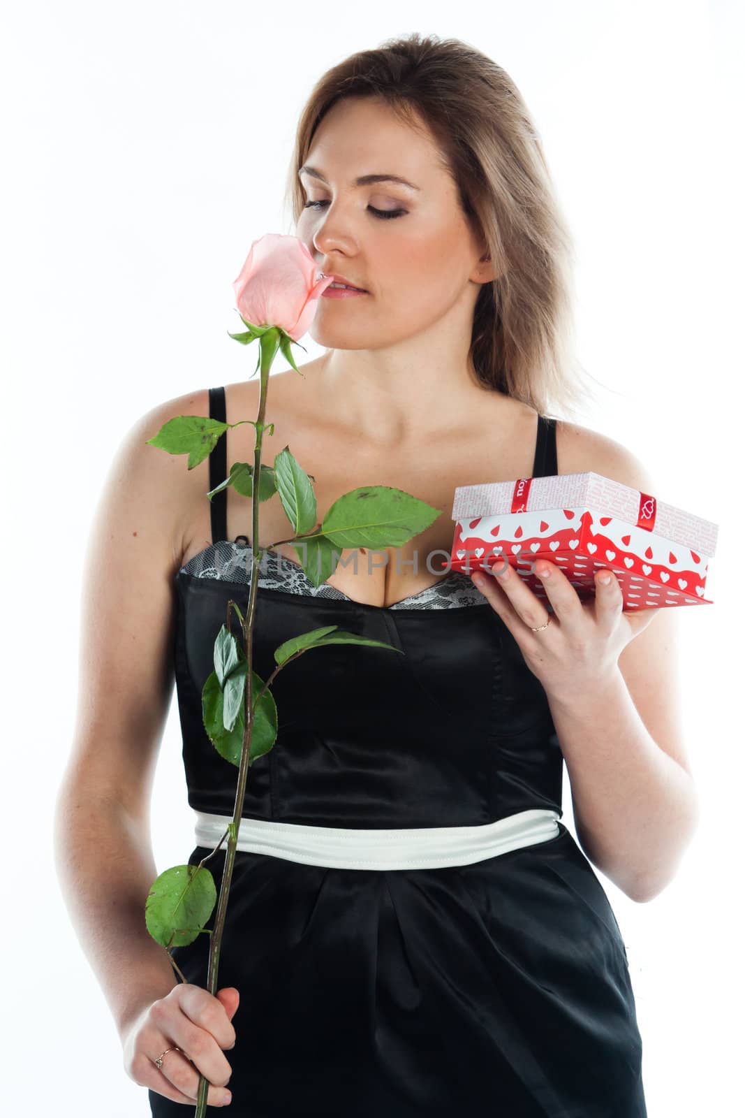 portrait of a young and beautiful girl with a gift and a rose