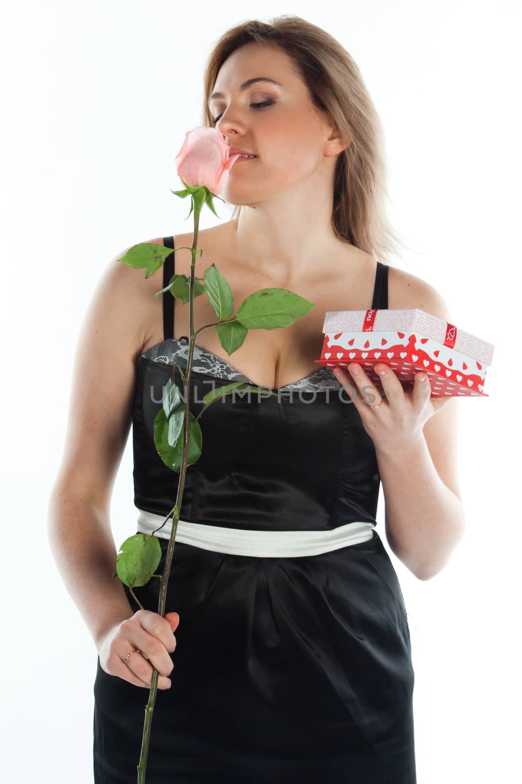portrait of a young and beautiful girl with a gift and a rose