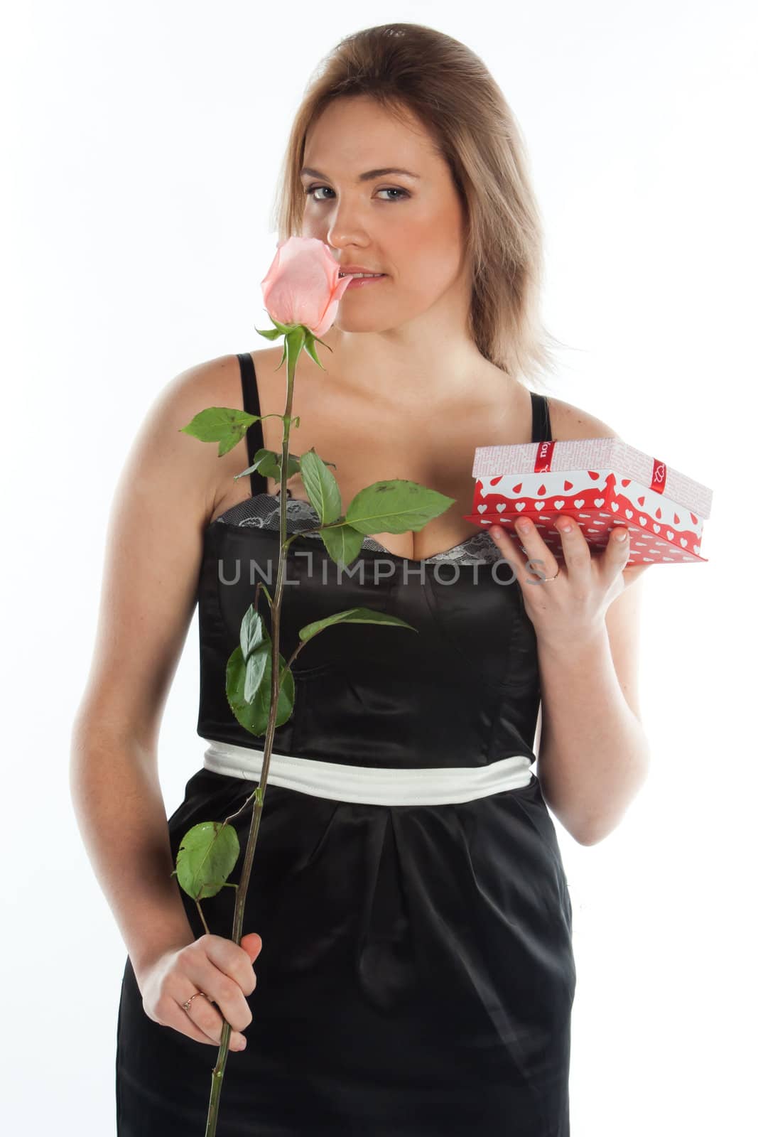 portrait of a young and beautiful girl with a gift and a rose