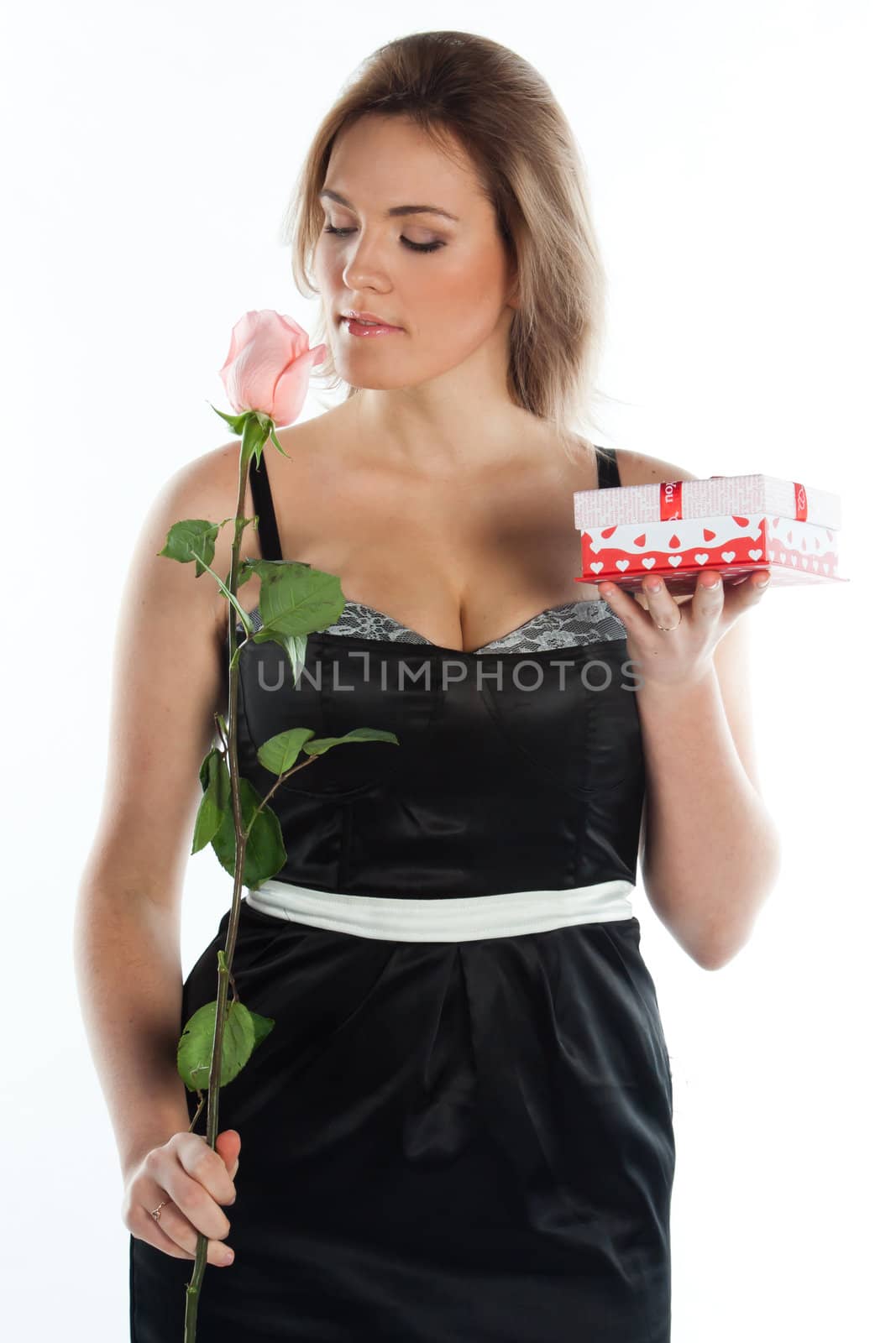 portrait of a young and beautiful girl with a gift and a rose