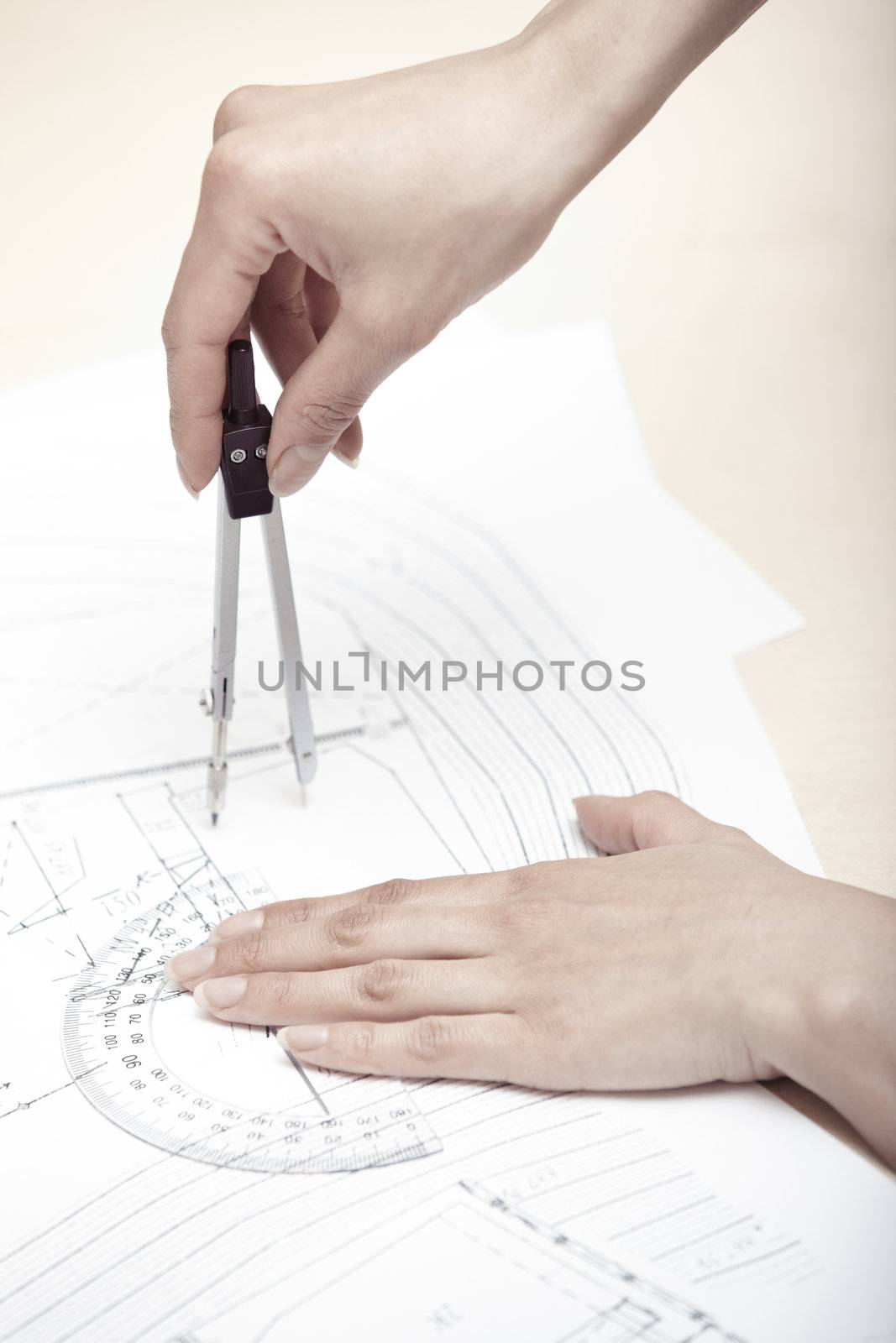 Hands of engineer working on a construction plan