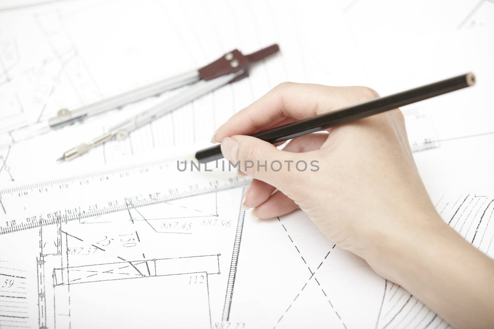 Hand of engineer working on a construction plan