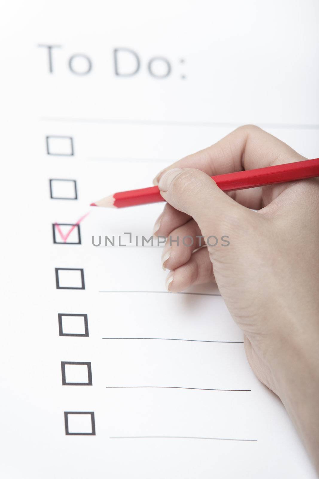 Human hand writing on a checklist document