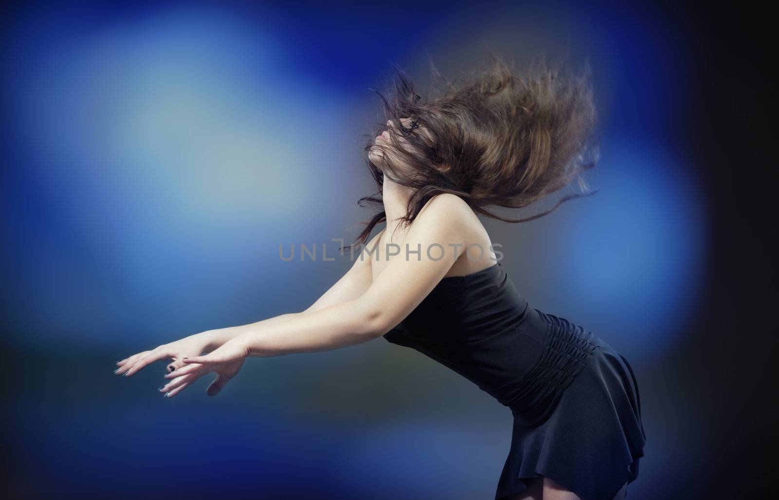 Elegant lady dancing in front of disko light