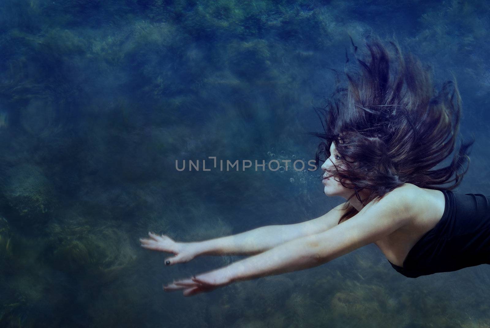 Beautiful lady swimming and diving underwater