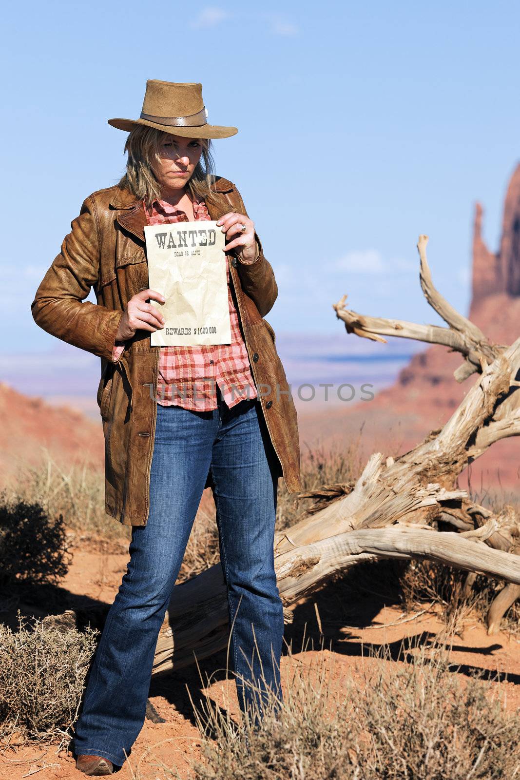 bad girl holding wanted paper at Monument Valley